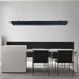 "Black modern pendant light with gold accents hanging above a long table in a contemporary office space."