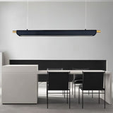 "Black modern pendant light with gold accents hanging above a long table in a contemporary office space."