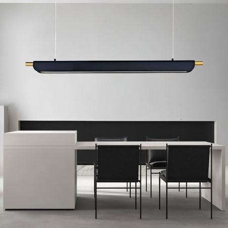 "Black modern pendant light with gold accents hanging above a long table in a contemporary office space."