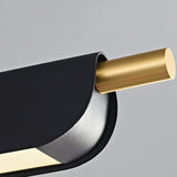 "Close-up of a modern pendant light showing a black metal frame and a gold cylindrical accent."