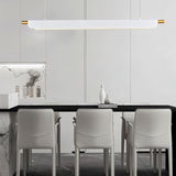 "White modern pendant light hanging above a dining table in a contemporary kitchen with white cabinets."