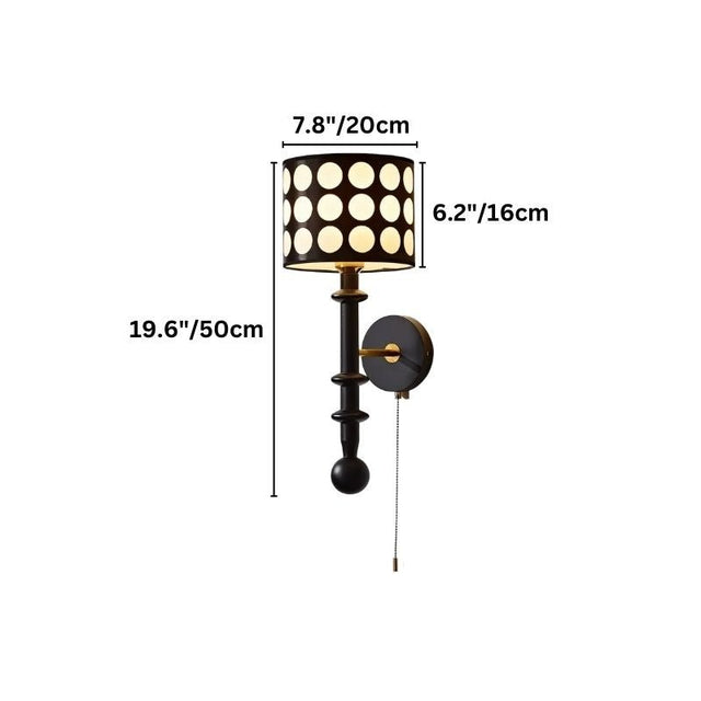 "A black and gold wall lamp with a patterned shade and pull chain, shown against a white background with dimension measurements."