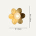 Flower-shaped wall lamp with golden petal panels and textured center sphere, shown against neutral background.