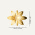 Gold flower-shaped wall lamp with brushed metal petals and spherical center on light background.