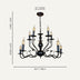 Black metal chandelier with eight candle-style lights and curved arms, displayed against a beige background.
