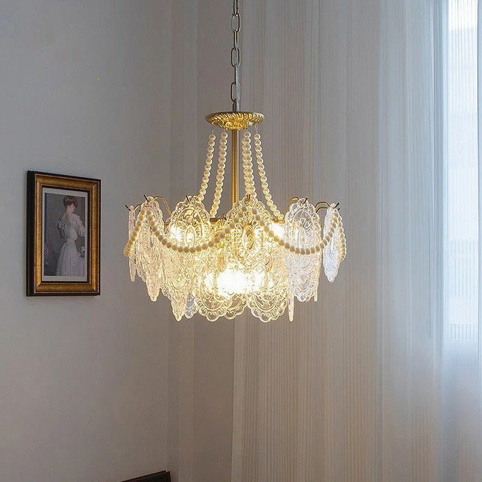Enhance the ambiance of your living space with the Bariq Glass Chandelier, its soft glow and elegant design creating a warm and inviting atmosphere.