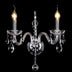 Crystal chandelier with clear glass arms and hanging crystals, illuminated against black background.