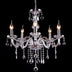 Crystal chandelier with five lit candle-style arms and hanging teardrop crystals against a black background.