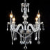 Crystal chandelier with clear glass arms and dangling prisms, featuring four lit candle-style bulbs against a black background.