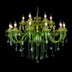 Green crystal chandelier with twelve candle-style lights and hanging glass prisms on black background.