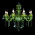 Green crystal chandelier with eight candle-style lights and dangling crystal prisms displayed against a black background.