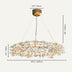 Gold branch-style pendant chandelier with crystal accents suspended against a neutral background.