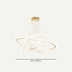 Gold-finished modern chandelier with orbital rings and hanging strings on a neutral background.