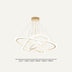 Gold and white modern orbital chandelier with multiple curved rings and hanging strings against a neutral background.