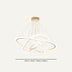 Modern gold pendant chandelier with orbital rings and hanging strings against a neutral background.