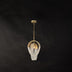 Pendant chandelier with brass frame and white beaded shade hanging from chain against dark background.