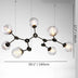 Black metal chandelier with eight frosted glass globe shades and warm LED lights against a white background.