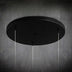 Black circular ceiling pendant light with four hanging cord suspensions against a textured gray wall.