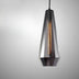 Modern smoked glass pendant light with geometric faceted shade and warm Edison-style filament bulb on gray background.