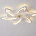 Modern white LED ceiling light with curved orbital arms and integrated lighting, mounted on white ceiling.