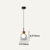 Pendant light with smoky glass shade and wood accent on black cord against neutral background.