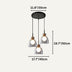Three-light pendant fixture with black canopy and clear glass shades in a modern minimalist style.