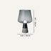 Modern table lamp with gray frosted glass shade and black cone base on neutral background.