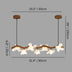 Linear floral chandelier with wood branch design and white flower-shaped glass shades, measures 80cm wide, hanging on a gray 