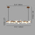 Linear ceiling light with wooden branch design and white flower-shaped bulbs on a plain grey background, 47.2 inches long.