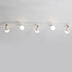 Five-light ceiling fixture with white shades and natural wood accents mounted on white ceiling.