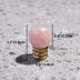 Rose quartz crystal sphere knob with brass base shown with dimensions on textured gray background.