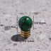 Green malachite crystal knob with brass base displayed on sandy surface with measurement dimensions.