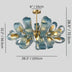 Teal textured chandelier with brass accents and curved petal-shaped arms against a gray background.