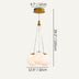 Three frosted white glass spheres suspend from brass hardware in a mid-century modern pendant light against a neutral background.