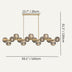 Linear chandelier with brass frame and ribbed glass spheres, shown against neutral background with dimensions labeled.