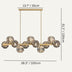 Linear chandelier with brass finish and ribbed glass globes, suspended from ceiling rod against neutral background.