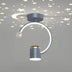 Modern curved ceiling light with gray metallic finish projecting stars and moon patterns on ceiling.