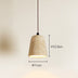 Travertine pendant light with warm brass interior and brown cord against neutral wall.