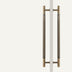 Antique brass double-sided door pull with textured grip handles on white background.