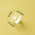 Clear acrylic cabinet knob with brass base on yellow background, shown with dimensions.