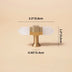 Brass T-bar cabinet pull with white crystal ends shown with dimensions on beige background.