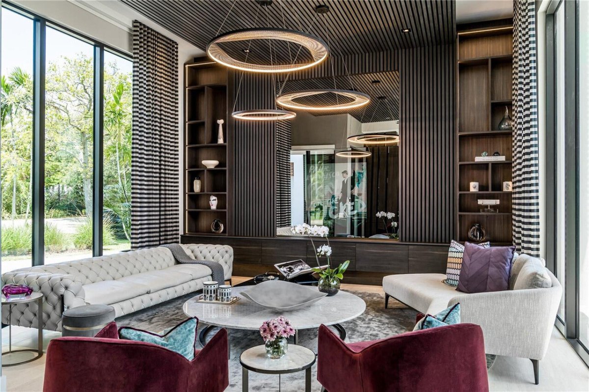 A large custom crafted Luce Chandelier elegantly hovers above the living room, acting as the room's stunning focal point.